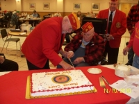 Nov10, 2010_ DetCmdt, Arnie assistancing oldest Marine cutting cake.JPG