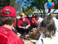 May 15Th_ Sgt-at-Arms Art Modler in Red&Yellow cover demostrating the proper way of making a hotdog.JPG