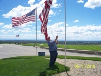 Jun11,2010_Cmdt Strawn hoisting up flag at Veterans Cemetery.JPG